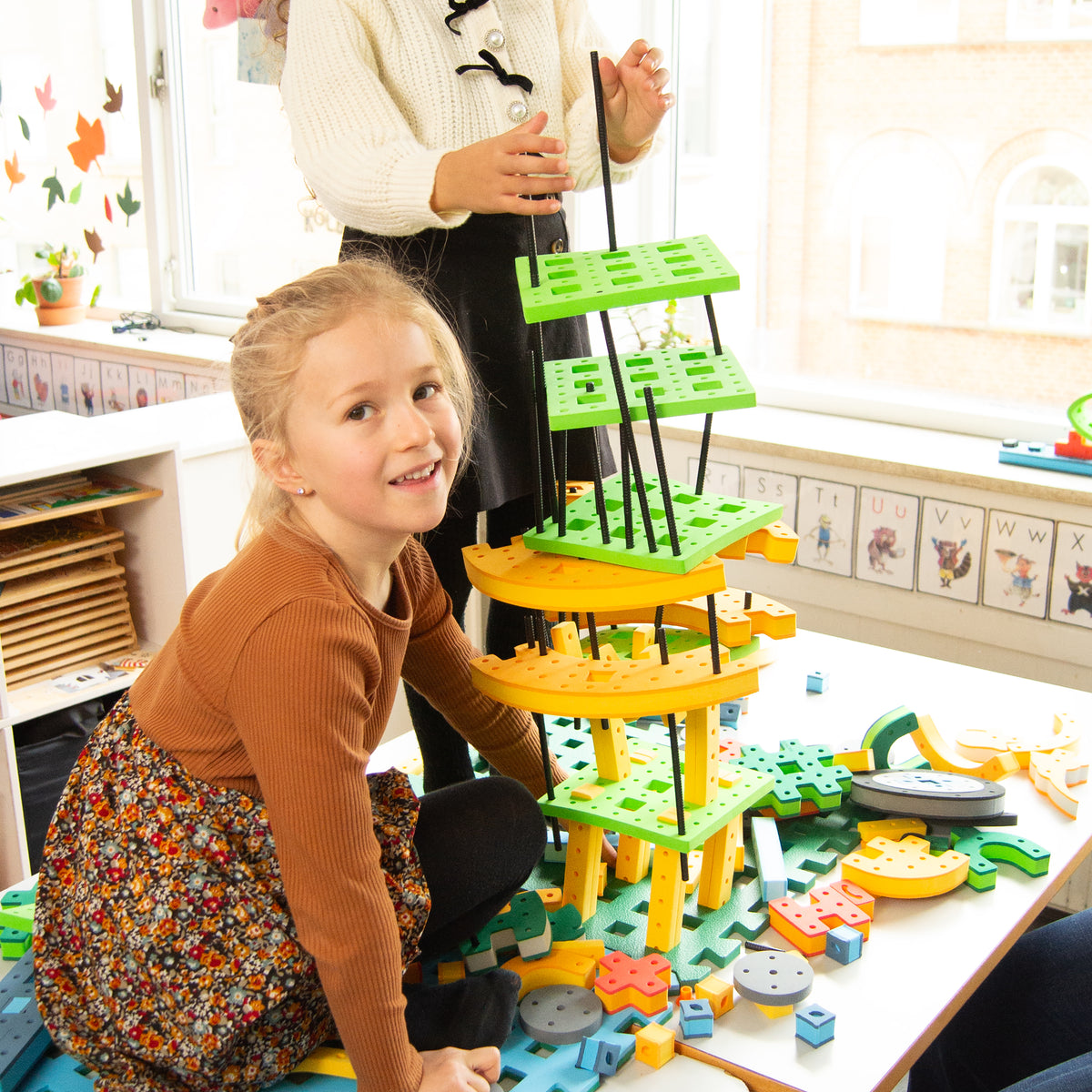 Kindergarten students successfully engineer an elaborate, tall architectural structure using BAKOBA STEM toys